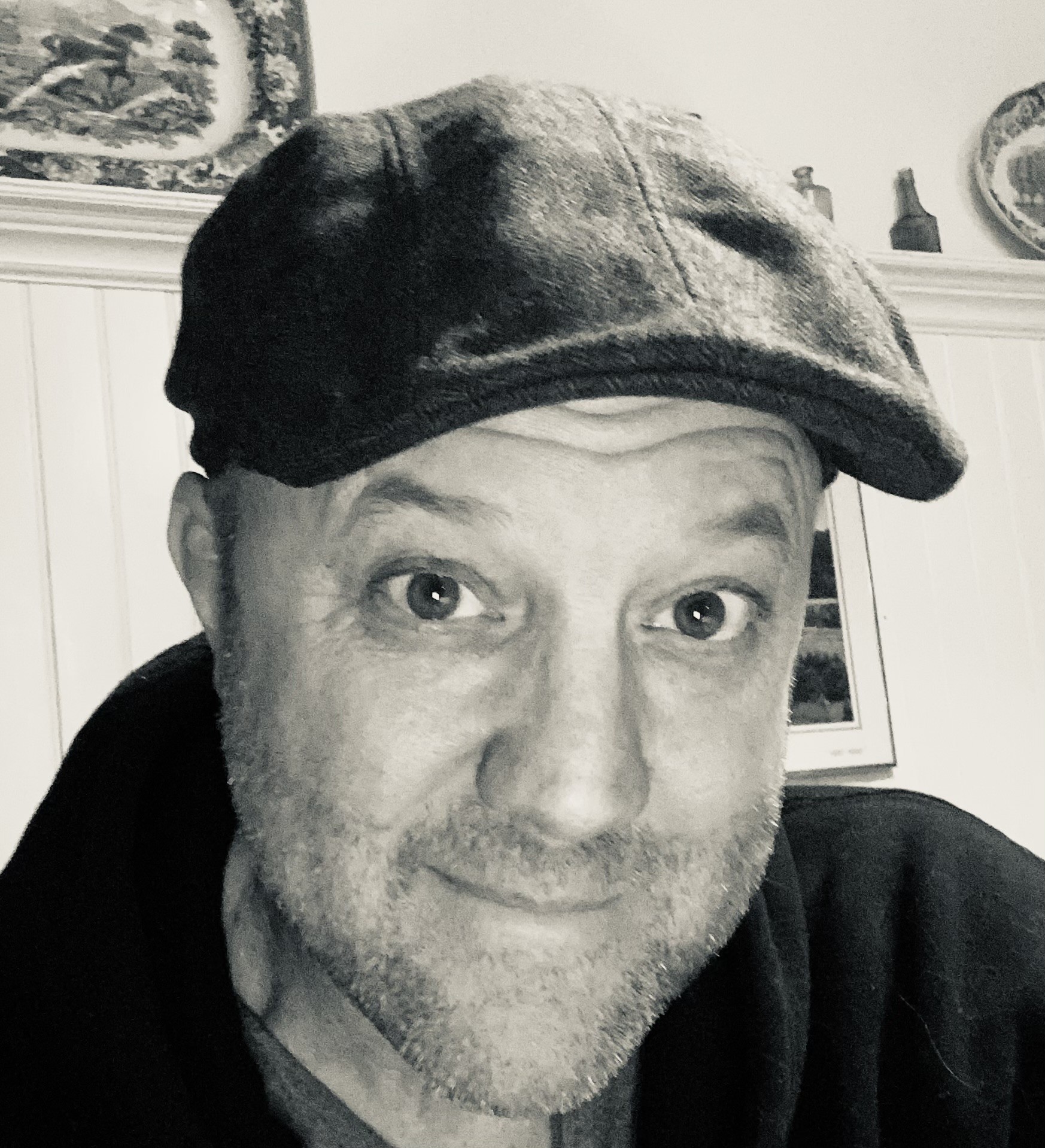 Peter MacKenzie Hammond wearing a flat cap